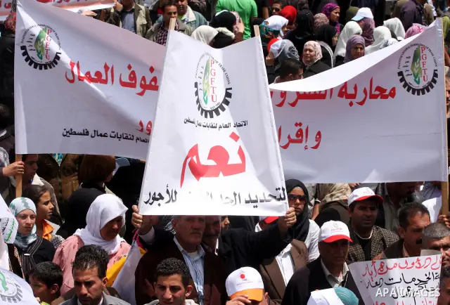 Palestinians hold a rally in the city of Ramallah in the Israeli occupied West Bank during May Day celebrations demanding jobs, freedom of movement between towns and cities currently restricted by Israeli army checkpoint...