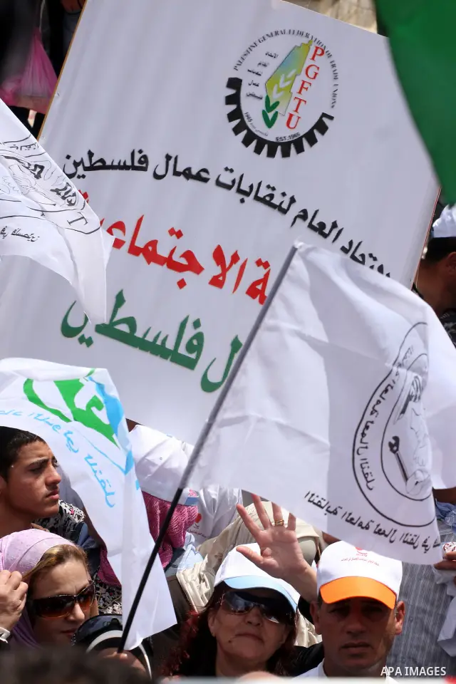 Palestinians hold a rally in the city of Ramallah in the Israeli occupied West Bank during May Day celebrations demanding jobs, freedom of movement between towns and cities currently restricted by Israeli army checkpoint...