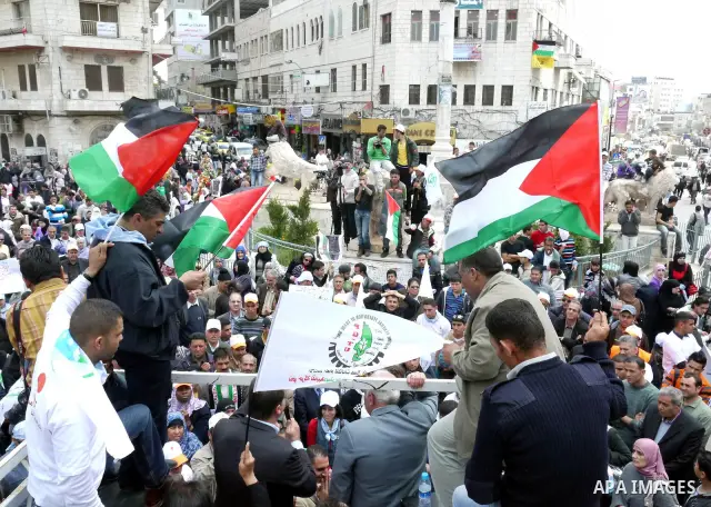 Palestinians hold a rally in the city of Ramallah in the Israeli occupied West Bank during May Day celebrations demanding jobs, freedom of movement between towns and cities currently restricted by Israeli army checkpoint...