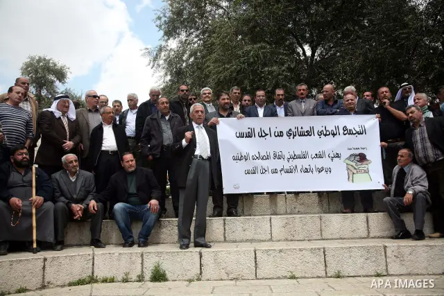 Palestinians residents of Jerusalem demonstrate at the Damascus Gate outside Jerusalem's old city on May 1, 2011, as they welcome reports that rival political movements the secularist Fatah and radical Islamist Hamas fac...