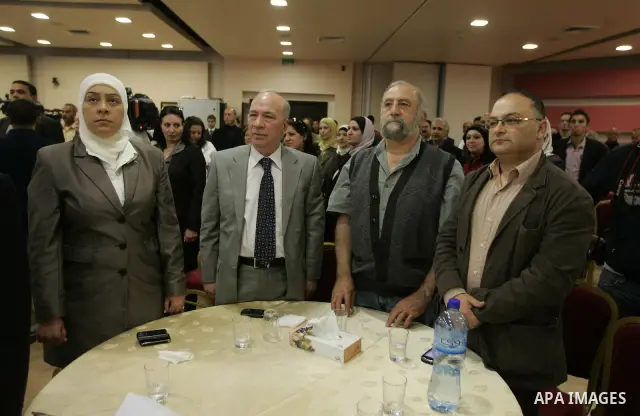 Palestinians attend a celebration to honor the photojournalists who won in the contest of "Palestine for Photography" at the Red Crescent hall in the West Bank city of Ramallah on May 2,2011. Photo by Issam Rimawi