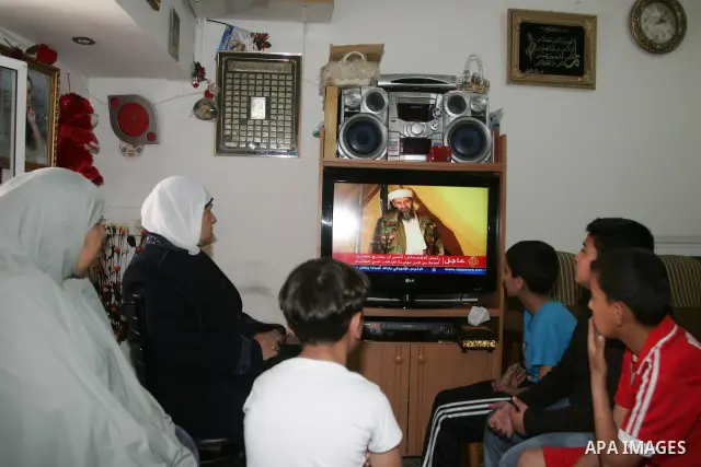 Members of Palestinian family watch a cable TV news report about the killing of Osama bin Laden, at their home in Jerusalem's old city on May 2, 2011. The United States has killed Al-Qaeda leader Osama bin Laden nearly 1...