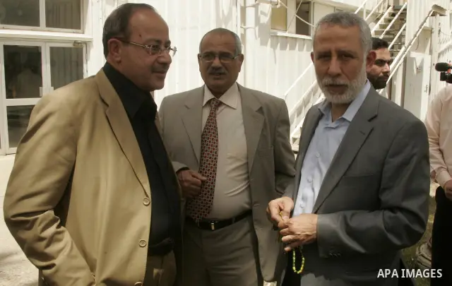 Palestinian Islamic Jihad leader Mohammed al-Hindi speaks with Faisal Abu Shahla, Gaza-based member of Palestinian leader Mahmud Abbas's Fatah faction, as they arrive at the Rafah border terminal in the southern Gaza Str...