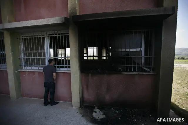 A Palestinian inspects a mosque, situated inside a school, which was allegedly burnt by Israeli settlers in the West Bank village of Hawara, south of Nablus, on May 03, 2011 as Israeli police arrested a group of Israeli...