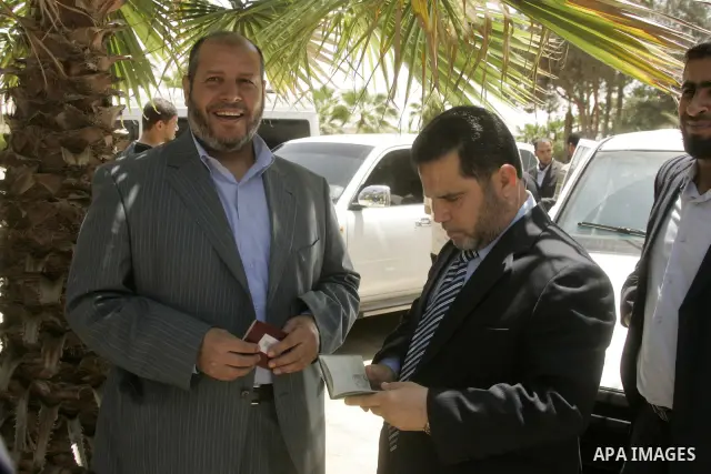 Senior members of the Islamic Hamas movement Khalil al-Hayeh and Salah al-Bardaweel arrive at the Rafah border terminal in the southern Gaza Strip on May 03, 2011 before crossing to Egypt, as Palestinian factions will in...