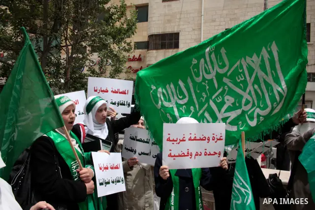 Palestinian women supporters of the Hamas Islamist movement demonstrate in the West Bank city of Hebron on May 04, 2011 as Palestinians in the West Bank and Gaza Strip gather to celebrate and welcome a reconciliation dea...