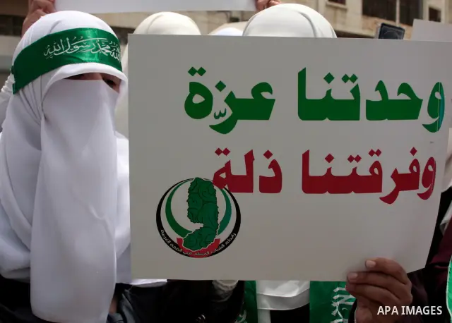 Palestinian women supporters of the Hamas Islamist movement demonstrate in the West Bank city of Hebron on May 04, 2011 as Palestinians in the West Bank and Gaza Strip gather to celebrate and welcome a reconciliation dea...