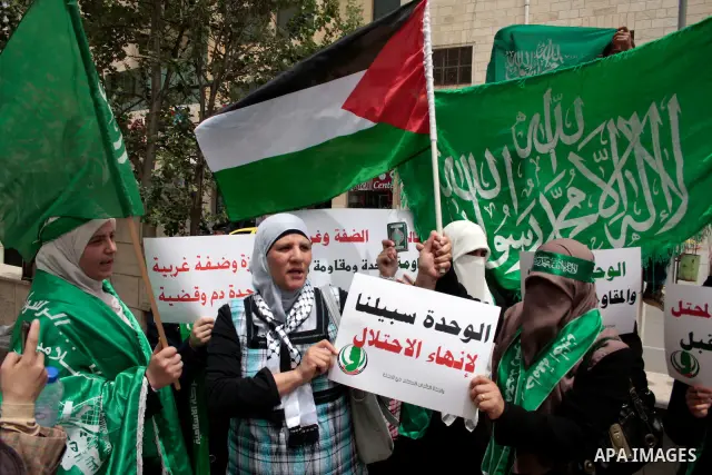 Palestinian women supporters of the Hamas Islamist movement demonstrate in the West Bank city of Hebron on May 04, 2011 as Palestinians in the West Bank and Gaza Strip gather to celebrate and welcome a reconciliation dea...