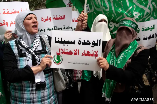 Palestinian women supporters of the Hamas Islamist movement demonstrate in the West Bank city of Hebron on May 04, 2011 as Palestinians in the West Bank and Gaza Strip gather to celebrate and welcome a reconciliation dea...