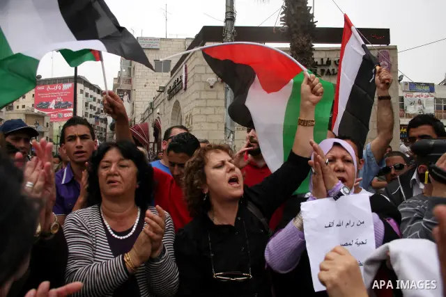 Palestinians celebrate during a rally in the West Bank city of Ramallah on May 04, 2011 as Palestinians in the West Bank and Gaza Strip gather to welcome a reconciliation deal signed by rival movements Hamas and Fatah in...