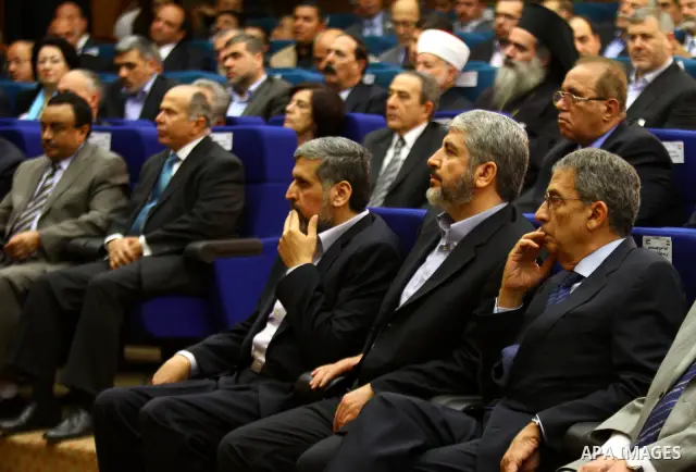 Palestinian Hamas leader Khaled Meshaal sits between the Arab League secretary general Amr Mussa and Jihad Islamic leader, Ramadan Shalah as they attend a reconciliation ceremony between the Fatah party and the Hamas mov...