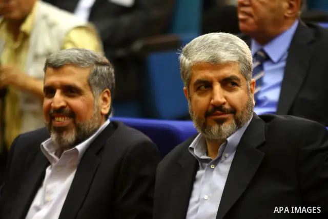 Palestinian Hamas leader Khaled Meshaal sits next to Jihad Islamic leader, Ramadan Shalah as they attend a reconciliation ceremony between the Fatah party and the Hamas movement in the Egyptian capital Cairo on May 4, 20...