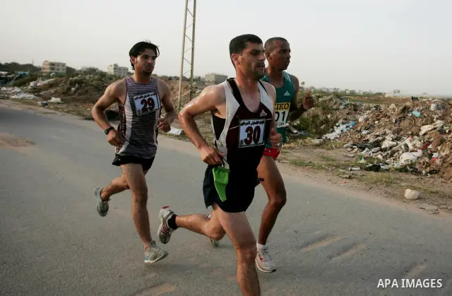 Palestinian racers speed along the waterfront in Gaza City on May 5, 2011 as he competes in the Gaza Strip's first-ever marathon which runs the entire length of the coastal enclave. Photo by Mohammed Othman