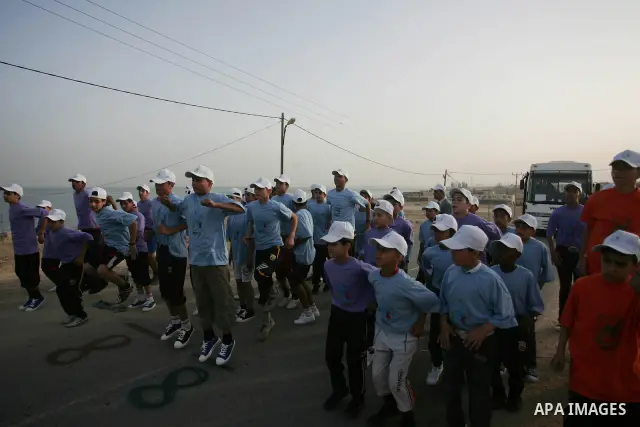 Palestinian schoolboys run in Beit Hanun on May 5, 2011 as they compete in the Gaza Strip's first-ever marathon which runs the entire length of the coastal enclave. Photo by Mohammed Othman