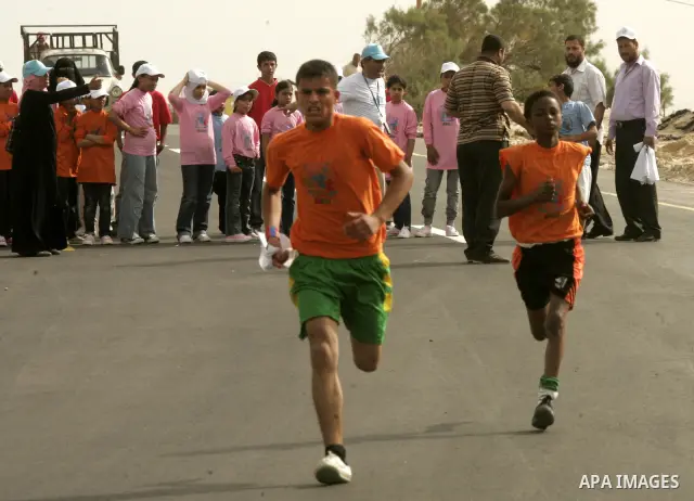Palestinian and foreign participants run in Rafah town in the southern Gaza Strip on May 5, 2011 as they compete in the Gaza Strip's first-ever marathon which runs the entire length of the coastal enclave. Photo by Abed...