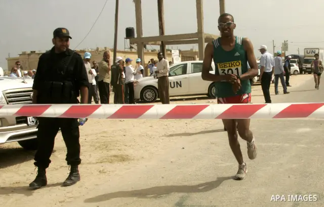 A Palestinian participant runs in Rafah town in the southern Gaza Strip on May 5, 2011 as they compete in the Gaza Strip's first-ever marathon which runs the entire length of the coastal enclave. Photo by Abed Rahim Khat...