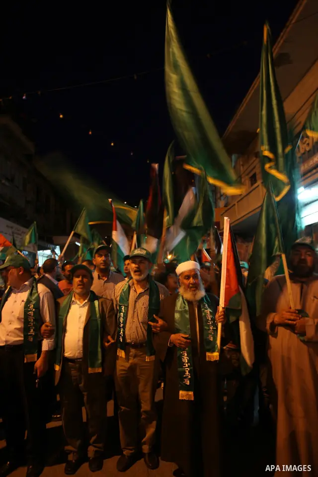 Palestinian Hamas supporters rally in the streets of the West Bank city of Nablus to celebrate on May 5, 2011 the political unity reconciliation deal between the Islamic group and the Fatah movement which was signed by t...