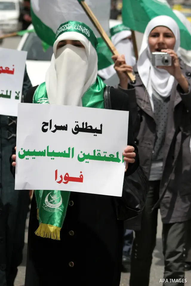 Palestinian Hamas supporters rally in the streets of the West Bank city of Hebron to celebrate on May 6, 2011 the political unity reconciliation deal between the Islamic group and the Fatah movement which was signed by t...