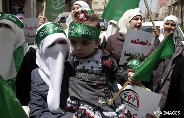 Palestinian Hamas supporters rally in the streets of the West Bank city of Hebron to celebrate on May 6, 2011 the political unity reconciliation deal between the Islamic group and the Fatah movement which was signed by t...