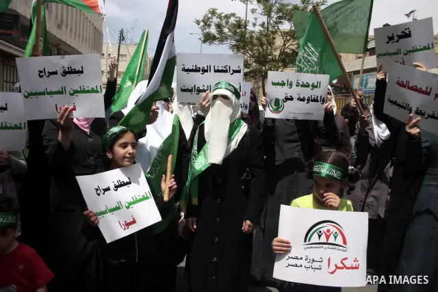 Palestinian Hamas supporters rally in the streets of the West Bank city of Hebron to celebrate on May 6, 2011 the political unity reconciliation deal between the Islamic group and the Fatah movement which was signed by t...