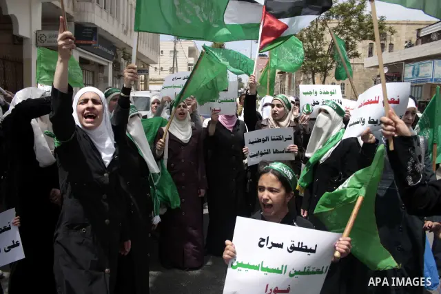 Palestinian Hamas supporters rally in the streets of the West Bank city of Hebron to celebrate on May 6, 2011 the political unity reconciliation deal between the Islamic group and the Fatah movement which was signed by t...