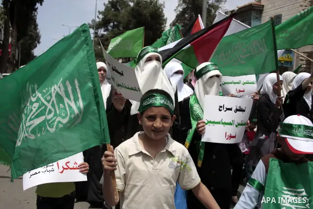 Palestinian Hamas supporters rally in the streets of the West Bank city of Hebron to celebrate on May 6, 2011 the political unity reconciliation deal between the Islamic group and the Fatah movement which was signed by t...