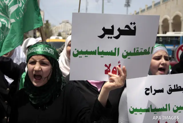 Palestinian Hamas supporters rally in the streets of the West Bank city of Hebron to celebrate on May 6, 2011 the political unity reconciliation deal between the Islamic group and the Fatah movement which was signed by t...