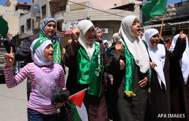 Palestinian Hamas supporters rally in the streets of the West Bank city of Tulkarem to celebrate on May 6, 2011 the political unity reconciliation deal between the Islamic group and the Fatah movement which was signed by...