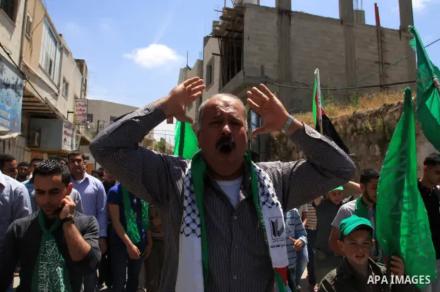 Palestinian Hamas supporters rally in the streets of the West Bank city of Tulkarem to celebrate on May 6, 2011 the political unity reconciliation deal between the Islamic group and the Fatah movement which was signed by...