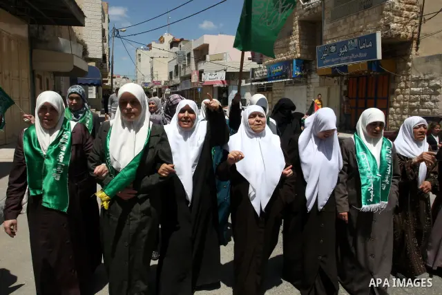 Palestinian Hamas supporters rally in the streets of the West Bank city of Tulkarem to celebrate on May 6, 2011 the political unity reconciliation deal between the Islamic group and the Fatah movement which was signed by...