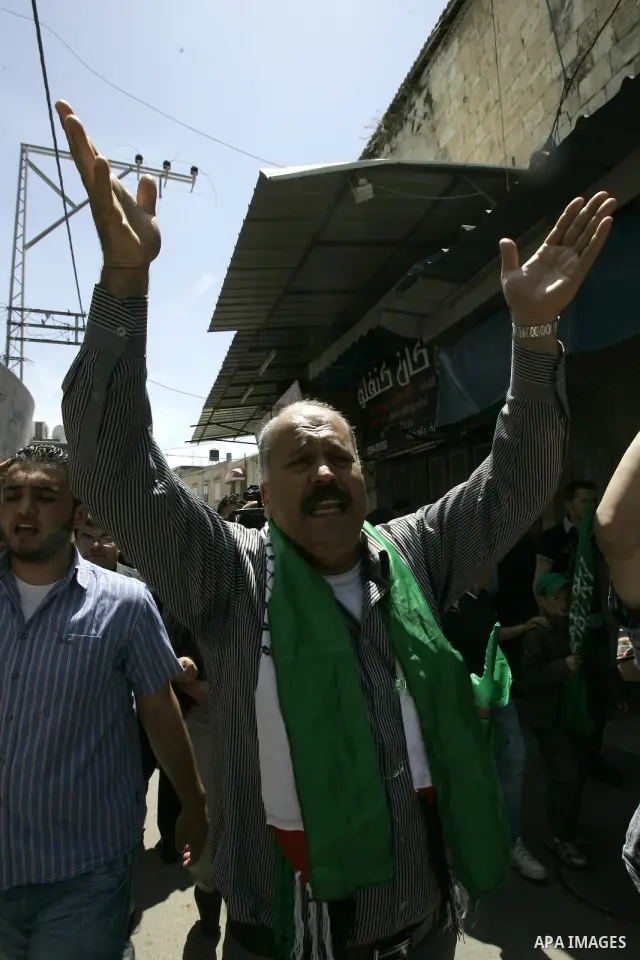 Palestinian Hamas supporters rally in the streets of the West Bank city of Tulkarem to celebrate on May 6, 2011 the political unity reconciliation deal between the Islamic group and the Fatah movement which was signed by...