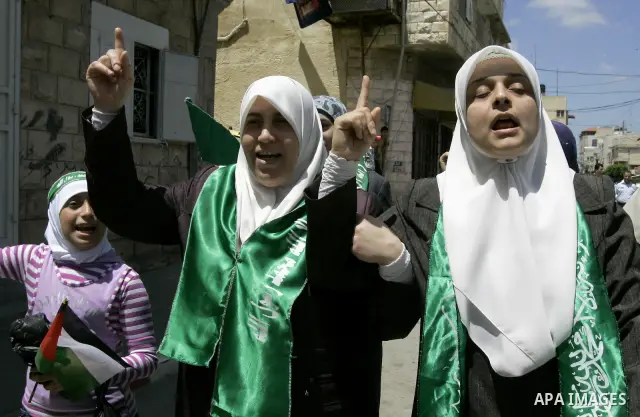 Palestinian Hamas supporters rally in the streets of the West Bank city of Tulkarem to celebrate on May 6, 2011 the political unity reconciliation deal between the Islamic group and the Fatah movement which was signed by...