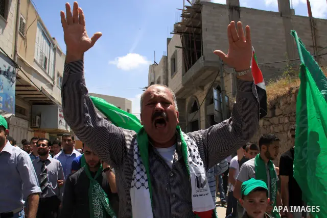 Palestinian Hamas supporters rally in the streets of the West Bank city of Tulkarem to celebrate on May 6, 2011 the political unity reconciliation deal between the Islamic group and the Fatah movement which was signed by...