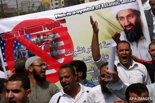 Egyptian Islamists, carrying a picture of late Al-Qaeda chief Osama bin Laden, march to the US embassy after the weekly Friday prayer in Cairo on May 6, 2011, during a demonstration to denounce the killing of Osama bin L...