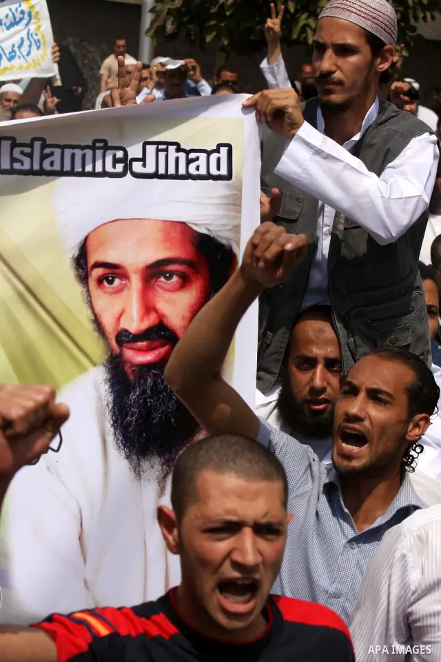 Egyptian Islamists, carrying a picture of late Al-Qaeda chief Osama bin Laden, march to the US embassy after the weekly Friday prayer in Cairo on May 6, 2011, during a demonstration to denounce the killing of Osama bin L...