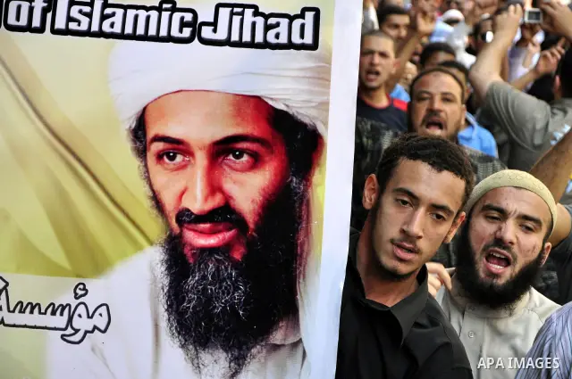 Egyptian Islamist groups hold a picture of Osama bin Laden, during a protest outside the U.S. embassy in Cairo, Egypt, Friday, May 6, 2011. Al-Qaida on Friday confirmed the killing of Osama bin Laden and warned of retali...