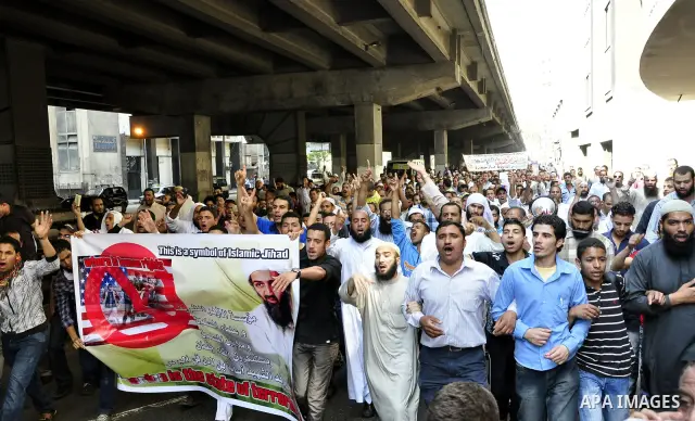 Egyptian Islamist groups hold a picture of Osama bin Laden, during a protest outside the U.S. embassy in Cairo, Egypt, Friday, May 6, 2011. Al-Qaida on Friday confirmed the killing of Osama bin Laden and warned of retali...