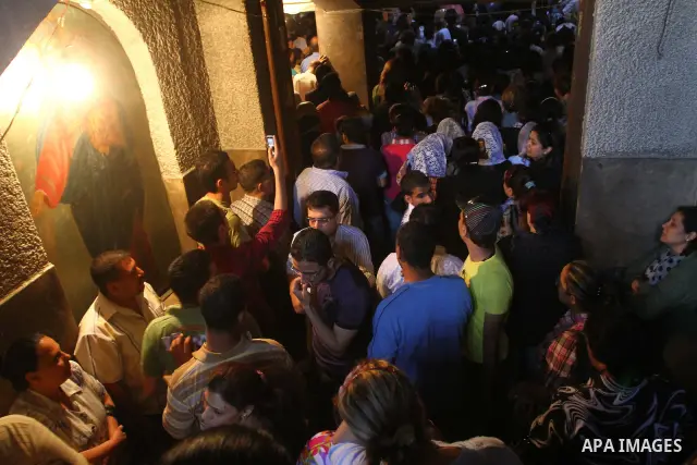 Egyptians Christians remove objects from the damaged Virgin Mary church in the popular area of Imbaba in the Egyptian capital of Cairo on May 8, 2011, after overnight clashes between Muslims and Christians which left 10...