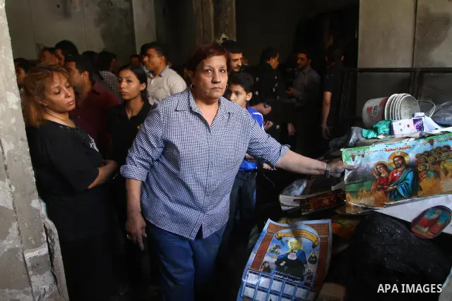 Egyptians Christians remove objects from the damaged Virgin Mary church in the popular area of Imbaba in the Egyptian capital of Cairo on May 8, 2011, after overnight clashes between Muslims and Christians which left 10...