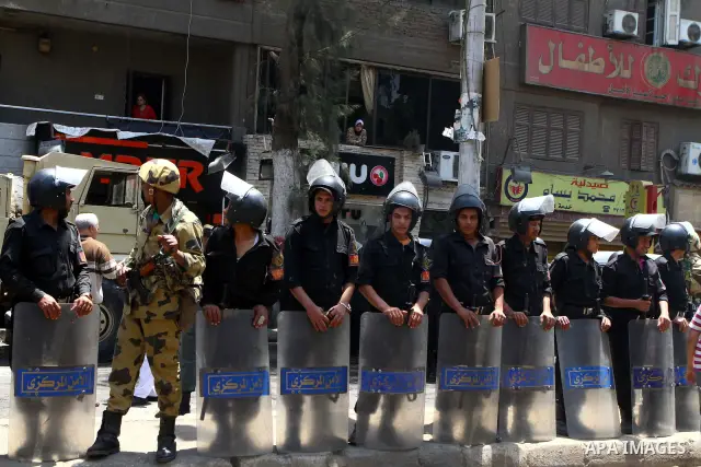 Egyptian military soldiers stand guard as Christians remove objects from the Virgin Mary church in the popular area of Imbaba in the Egyptian capital of Cairo on May 8, 2011 after clashes between Muslims and Christians w...