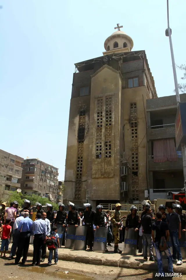 Egyptian military soldiers stand guard as Christians remove objects from the Virgin Mary church in the popular area of Imbaba in the Egyptian capital of Cairo on May 8, 2011 after clashes between Muslims and Christians w...