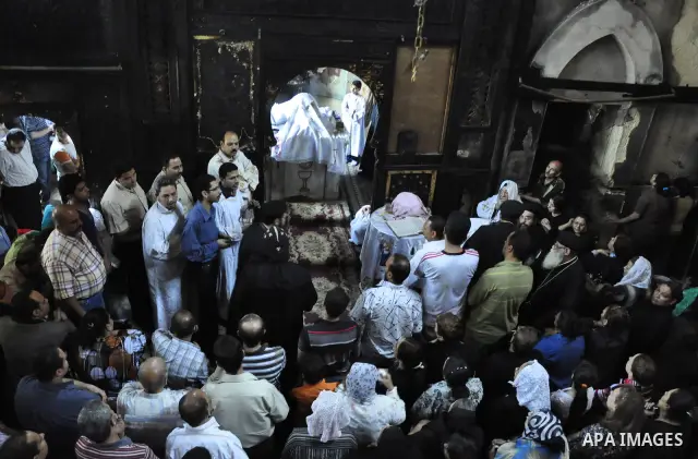 Egyptians Christian react at the damaged Virgin Mary church in the popular area of Imbaba in the Egyptian capital of Cairo on May 8, 2011, after overnight clashes between Muslims and Christians which left 10 people dead...