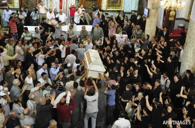 Egyptian Coptic Christians carry the coffin of a victim of sectarian clashes during a funeral in Cairo on May 8, 2011 as Egypt's military rulers warned they will use an "iron hand" to protect national security after clas...