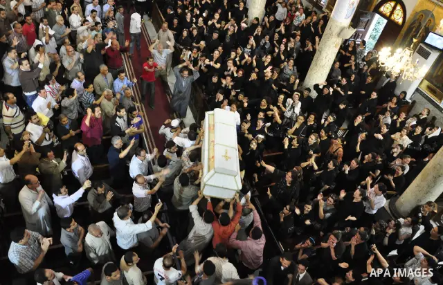 Egyptian Coptic Christians carry the coffin of a victim of sectarian clashes during a funeral in Cairo on May 8, 2011 as Egypt's military rulers warned they will use an "iron hand" to protect national security after clas...