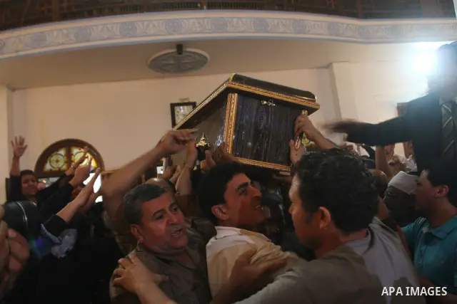 Egyptian Coptic Christians carry the coffin of a victim of sectarian clashes during a funeral in Cairo on May 8, 2011 as Egypt's military rulers warned they will use an "iron hand" to protect national security after clas...