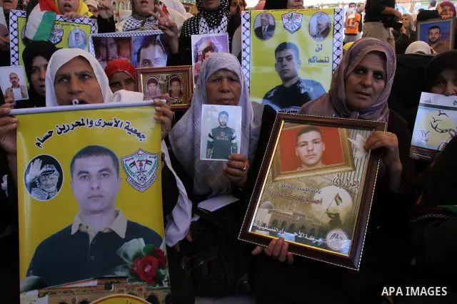 Palestinian women hold pictures of jailed relatives during a protest in Gaza city calling for their release from Israeli prisons at the headquarters of the International Red Cross in Gaza City May 9, 2011. Photo by Moham...