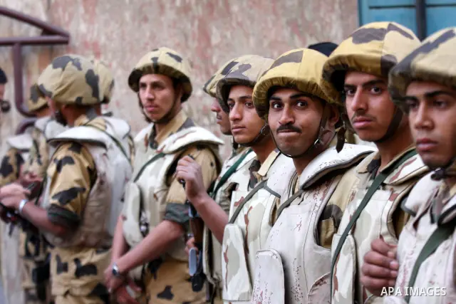 Egyptian soldiers stand guard as Coptic Christians take part in a protest in front of the U.S. embassy in Cairo on May 9, 2011, after clashes between Muslims and Christians in the Egyptian capital killed 12 people and in...