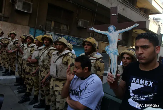 Egyptian soldiers stand guard as Coptic Christians take part in a protest in front of the U.S. embassy in Cairo on May 9, 2011, after clashes between Muslims and Christians in the Egyptian capital killed 12 people and in...