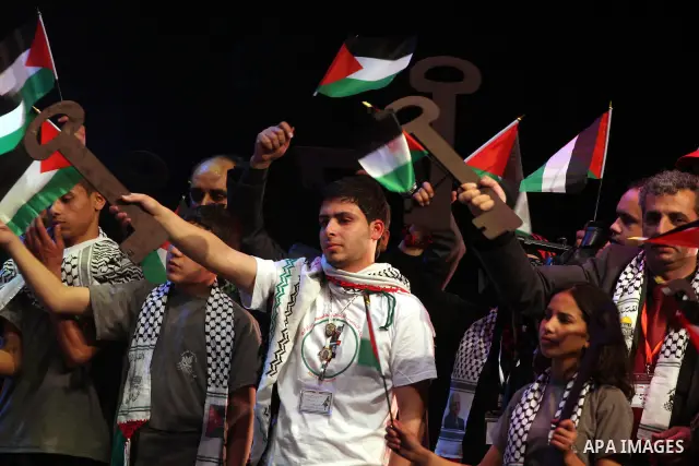 Palestinians hold flags and symbolic keys during a celebration in the West Bank city of Ramallah, Sunday, May 8, 2011 to commemorate the 63rd anniversary of Nakba, or catastrophe, the Arabic term used to describe the upr...