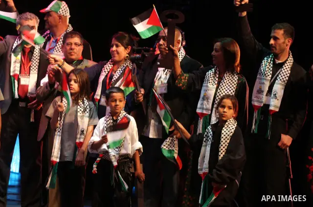 Palestinians hold flags and symbolic keys during a celebration in the West Bank city of Ramallah, Sunday, May 8, 2011 to commemorate the 63rd anniversary of Nakba, or catastrophe, the Arabic term used to describe the upr...
